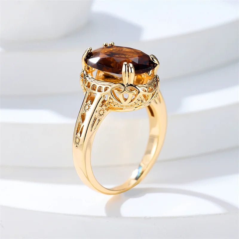 oval shaped brown gemstone inside a thick gold plated ring 