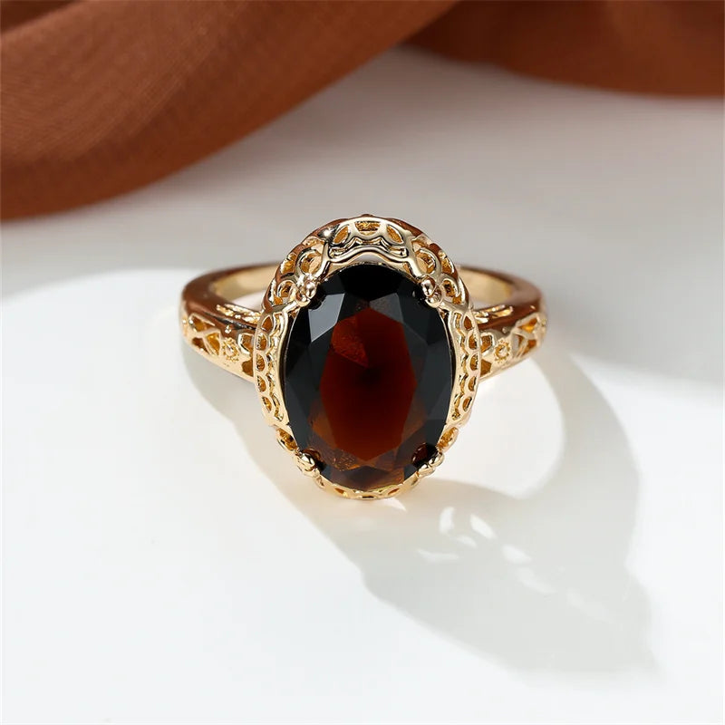 oval shaped brown gemstone inside a thick gold plated ring 